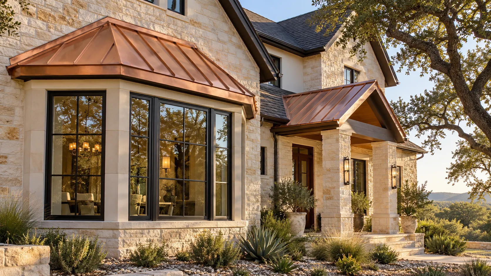 Bright copper standing seam roofs above a bay window and entry porch on a limestone home
